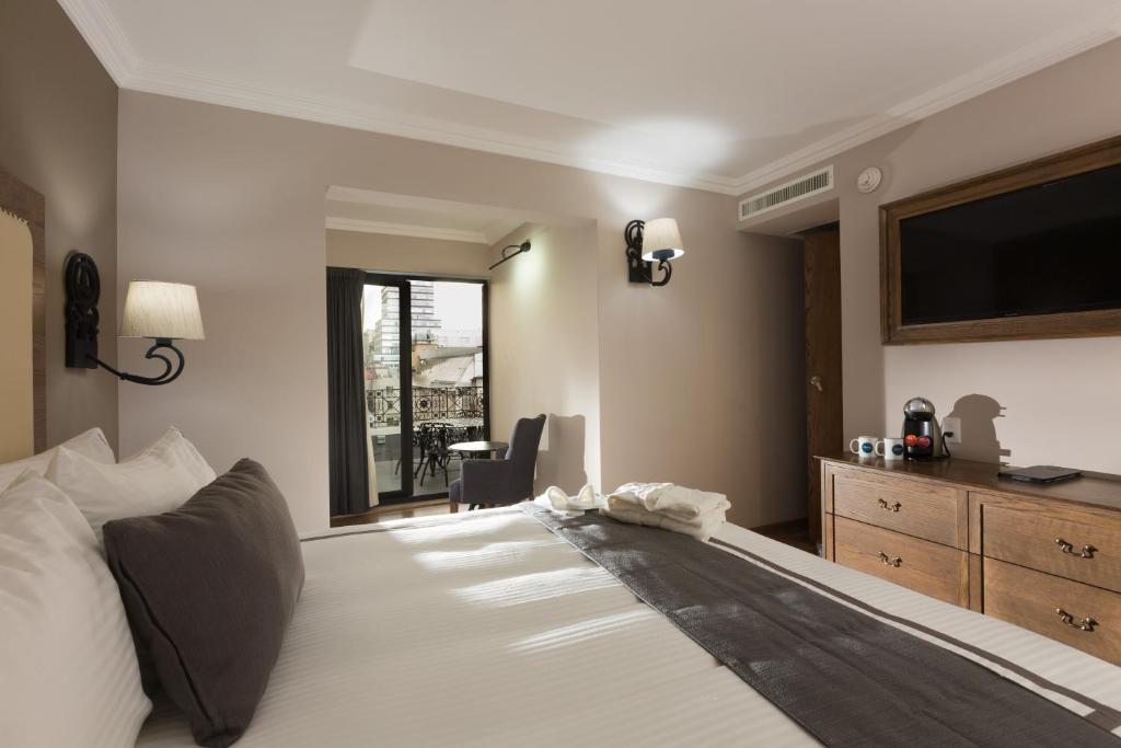 Postel nebo postele na pokoji v ubytování Historico Central Hotel