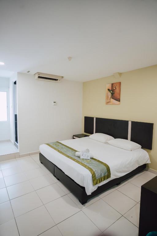 Postel nebo postele na pokoji v ubytování ND Hotel Melaka