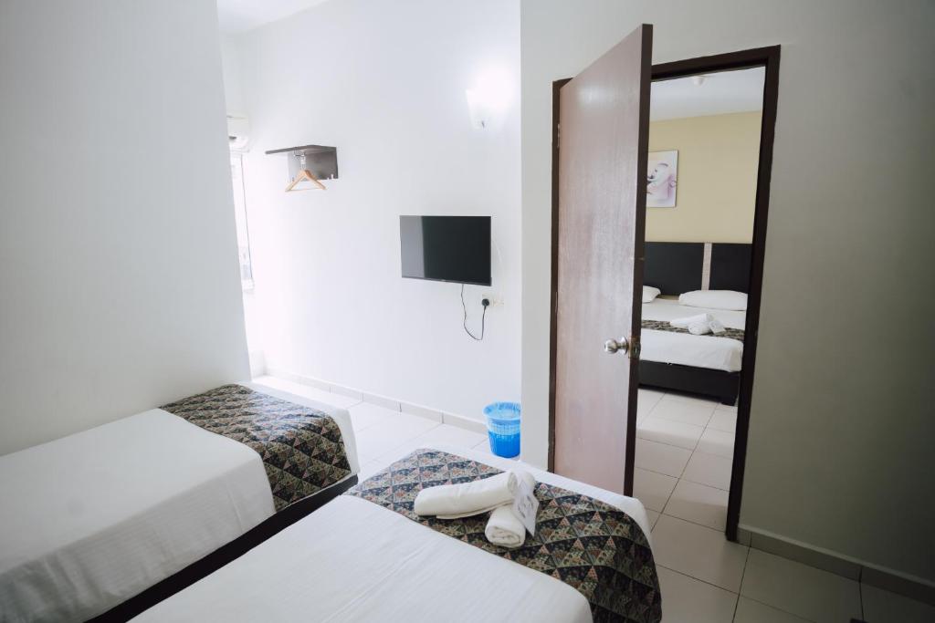 Postel nebo postele na pokoji v ubytování ND Hotel Melaka