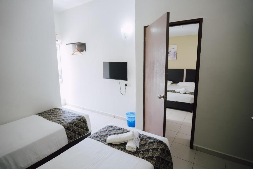 Postel nebo postele na pokoji v ubytování ND Hotel Melaka