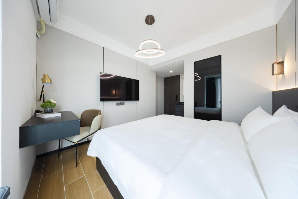Postel nebo postele na pokoji v ubytování 颐程City View Hotel-广州太古汇珠江新城体育中心石牌桥地铁站店-广交会专享