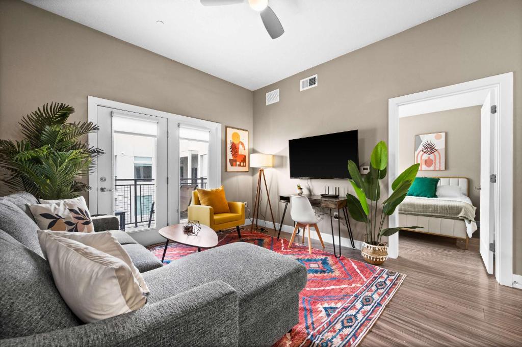 Una sala de estar con un sofá y un televisor. en Luxury High-Rise Living in SLC, en Salt Lake City