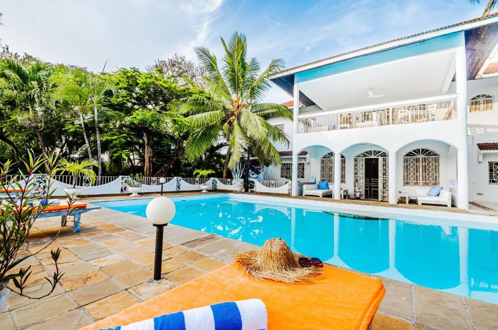 a villa with a swimming pool and a resort at Casa Zuri Diani Beach Villa in Diani Beach