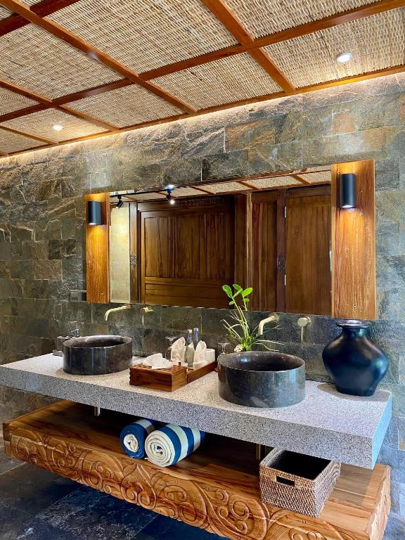 a bathroom with two sinks in a room at Abian Ayu Villa in Sidemen
