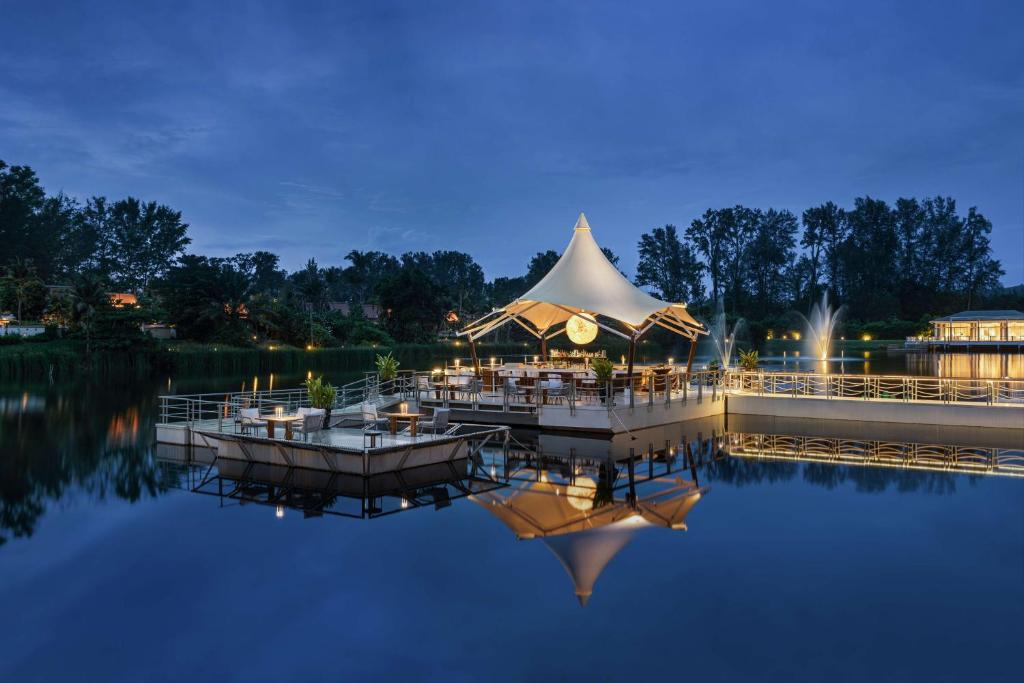 a wedding reception on the water at night at Banyan Tree Phuket in Bang Tao Beach