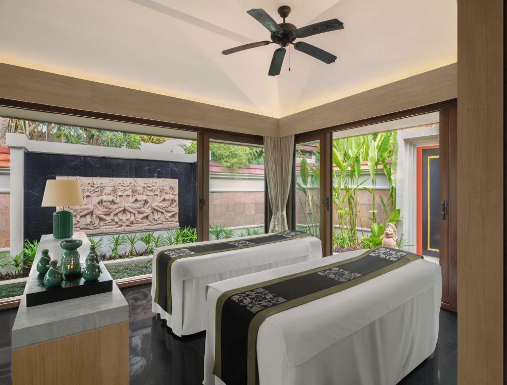 a bedroom with two beds and a ceiling fan at Banyan Tree Phuket in Bang Tao Beach