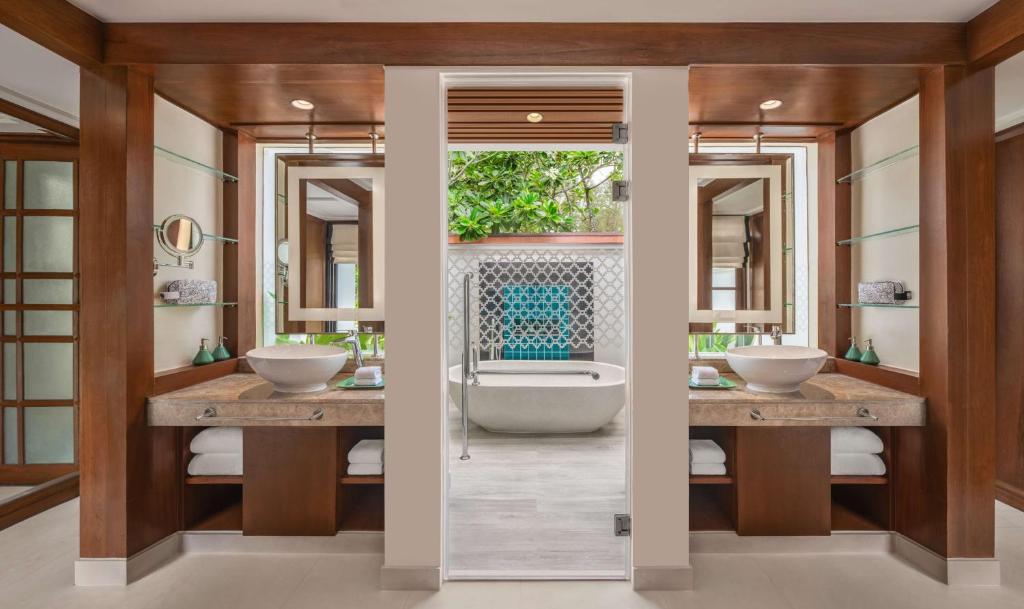 a bathroom with two sinks and a bath tub at Banyan Tree Phuket in Bang Tao Beach