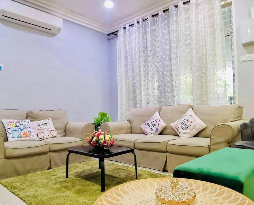 a living room with a couch and a table at Kuantan Setali ROOMSTAY by Iconique in Kuantan