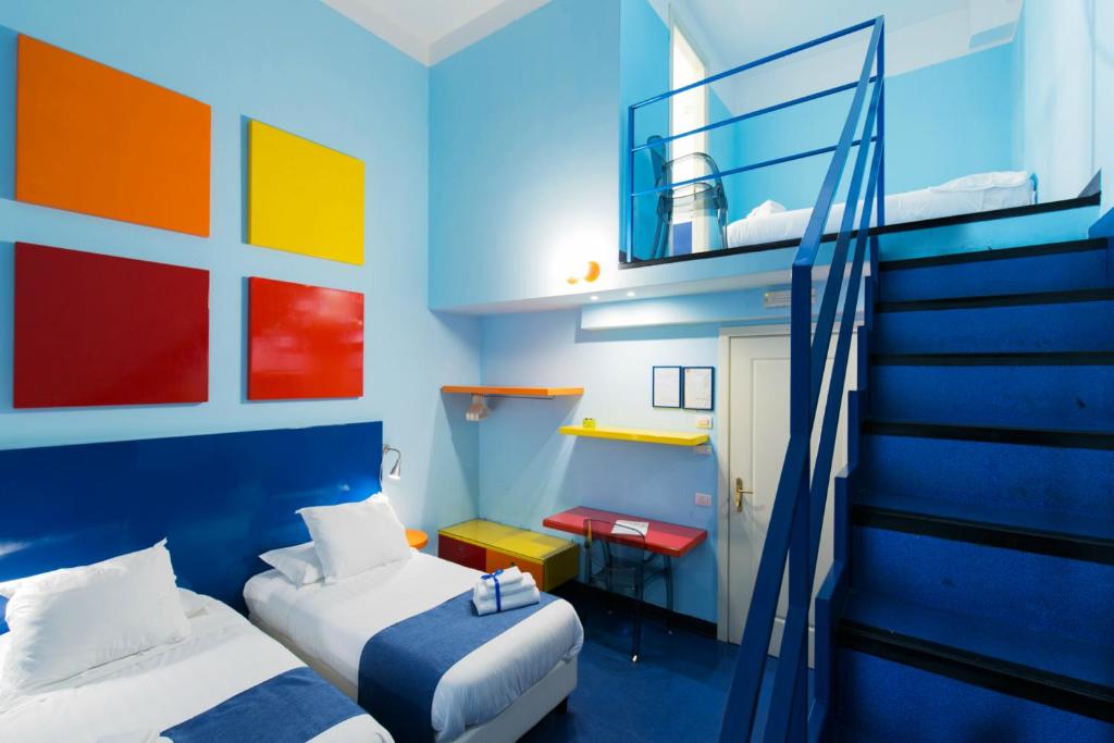 
a bedroom with blue walls and a blue bed at Correra 241 Lifestyle Hotel in Naples

