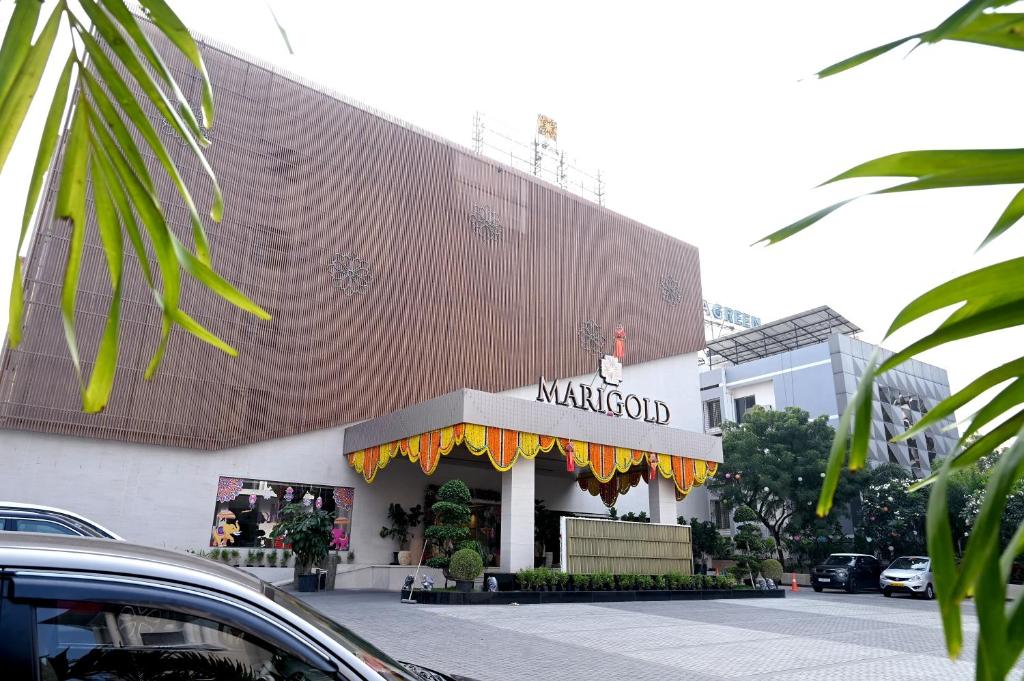 a store front of a building with a sign on it at MARIGOLD-Newly Renovated Hotel in Shirdi