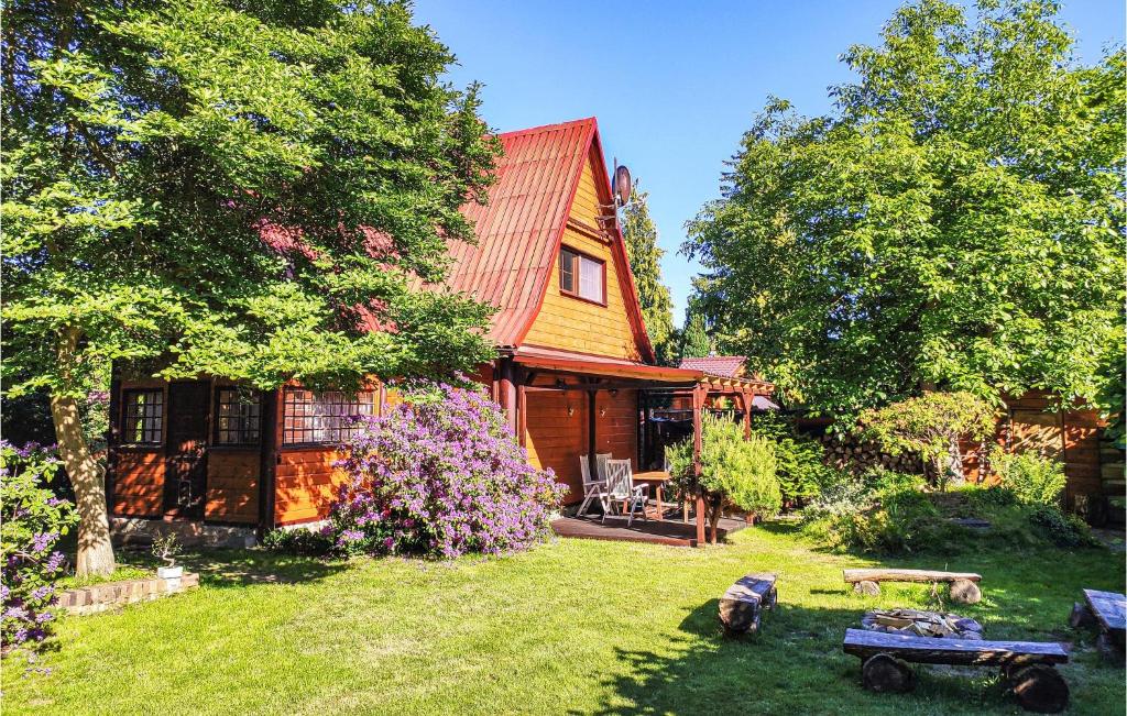 a house with a red roof and a yard at 3 Bedroom Lovely Home In Nowe Warpno in Nowe Warpno