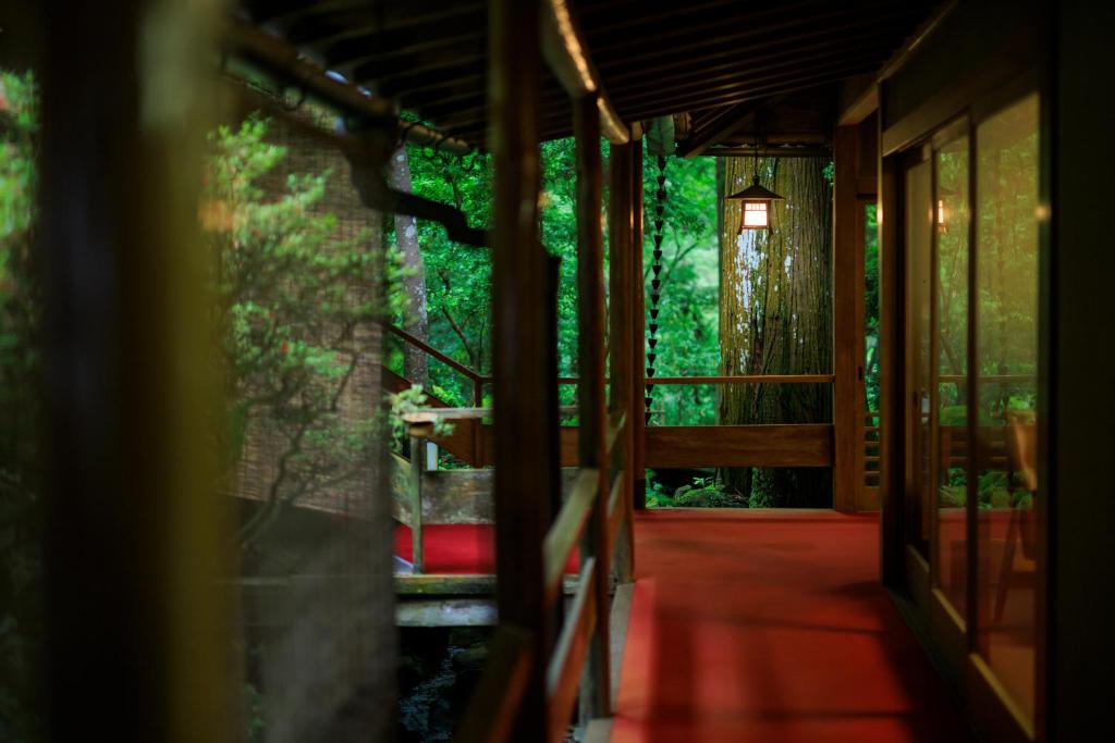 an entrance to a house with a hallway with trees at Tsukihitei in Nara