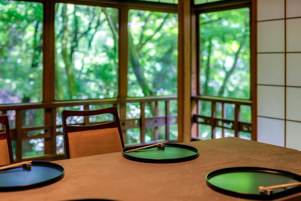 a table with two green plates on top of it at Tsukihitei in Nara