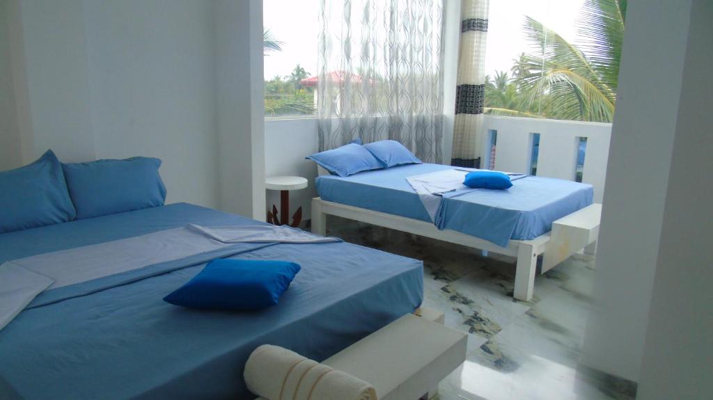 Postel nebo postele na pokoji v ubytování Ro Rich Hotel