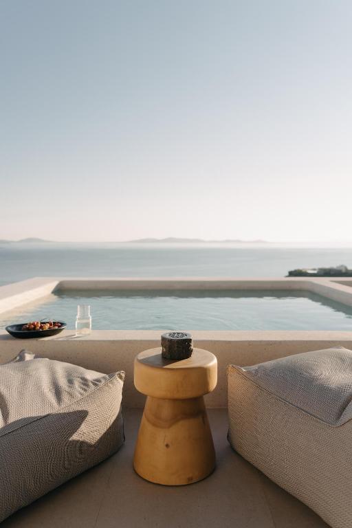 a living room with a view of a pool at Bard De Sol in Mikonos
