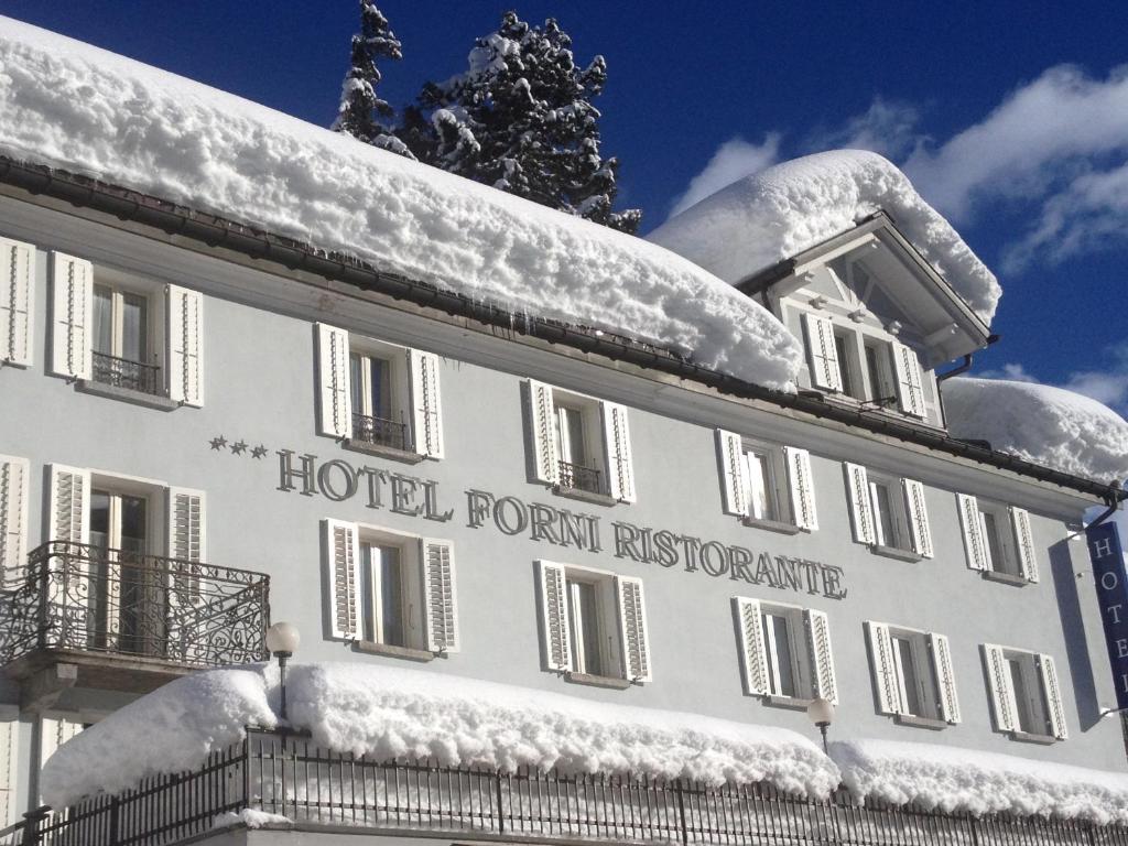 a hotel room with snow on the roof at Hotel & Restaurant Forni in Airolo