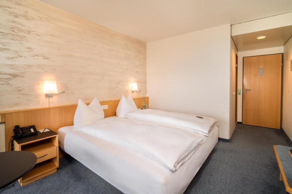 Voodi või voodid majutusasutuse Seeblick Höhenhotel toas
