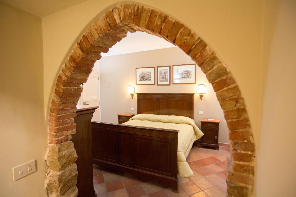 an archway in a bedroom with a bed in it at Palazzo Raho in Cefalù