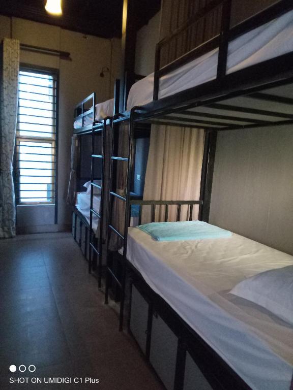Postel nebo postele na pokoji v ubytování Hostel FUJI