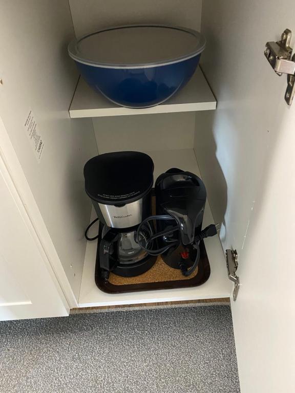 a coffee maker in a cabinet with a bowl at Our Place Up North BnB in Huntsville