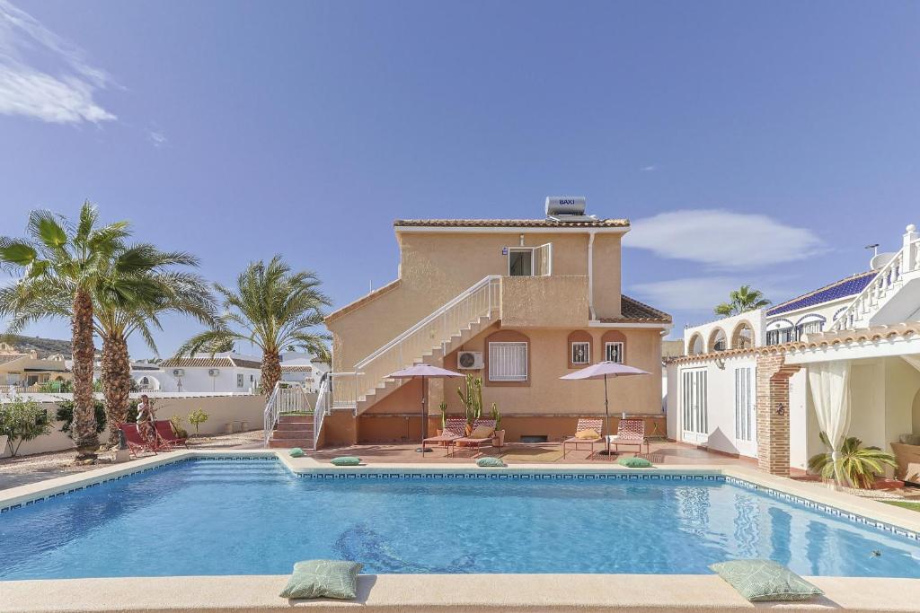 a large swimming pool in front of a house at Casa El Sole in Mazarrón