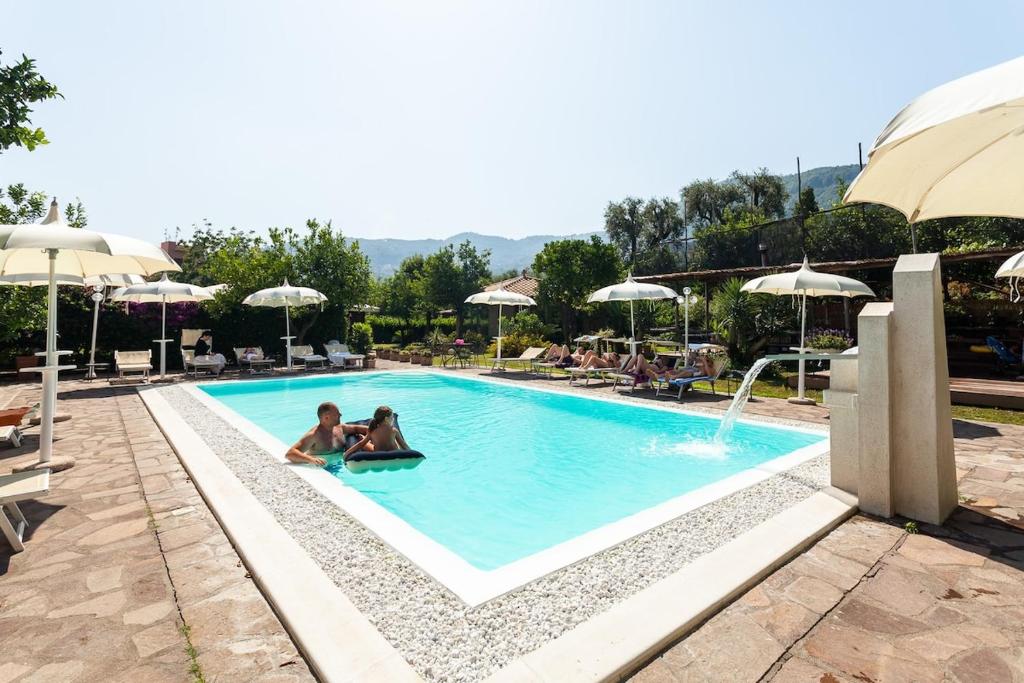 two people sitting in a swimming pool at a resort at Casa Lucy in Sorrento