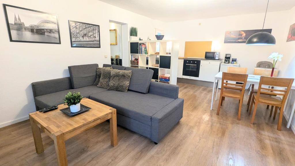 a living room with a couch and a table at Gästewohnung Köln-Longerich in Cologne