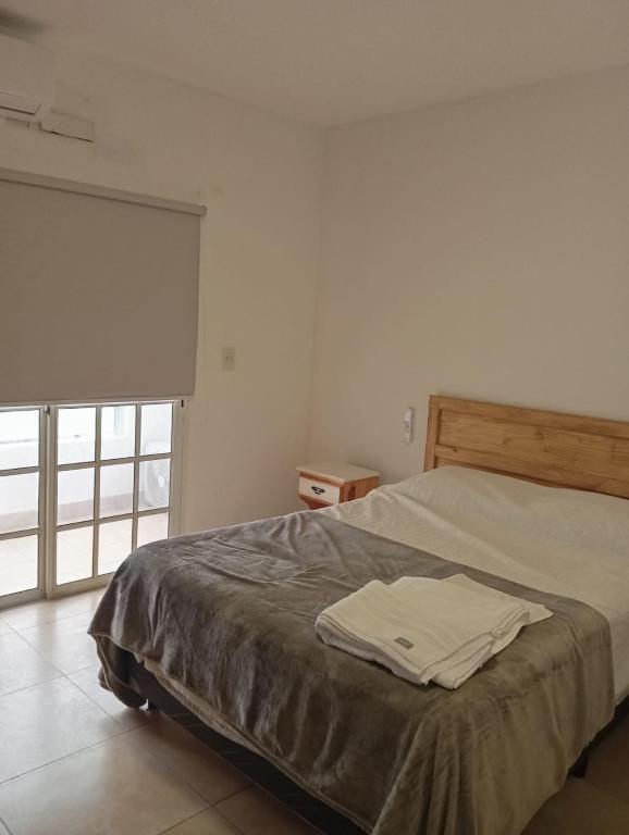a bedroom with a bed with a towel on it at Edificio San Lorenzo in Corrientes
