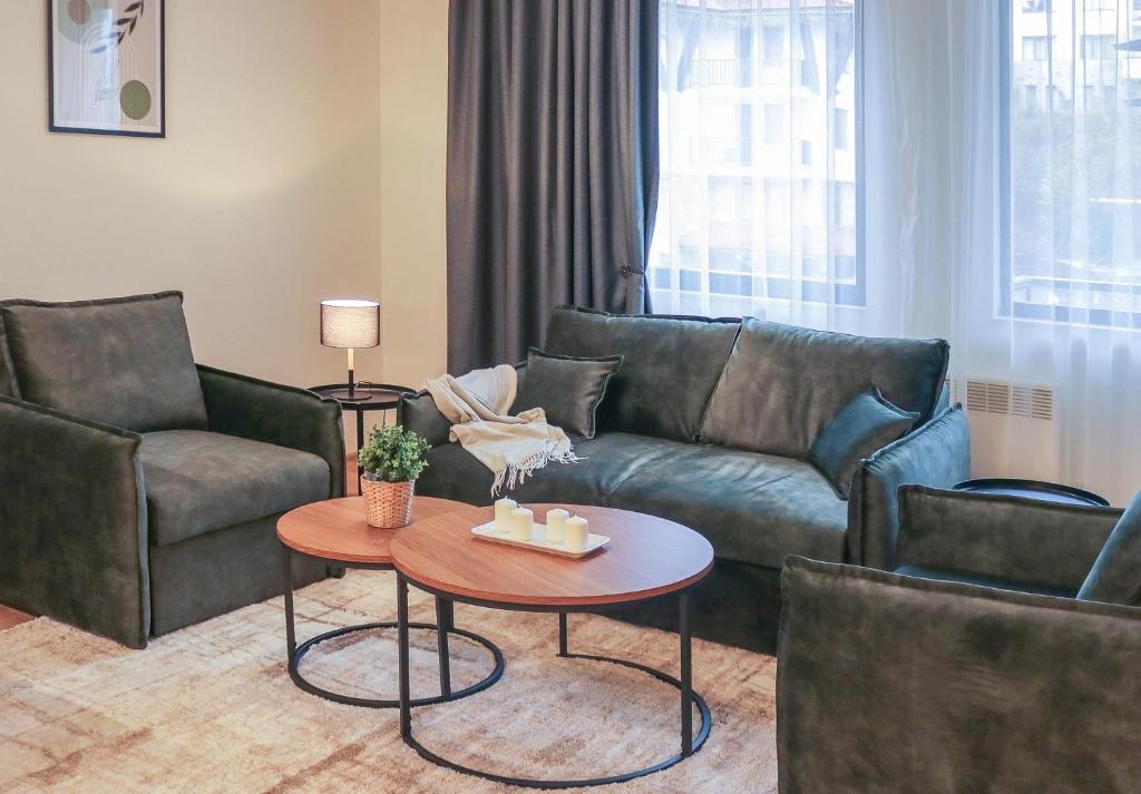 una sala de estar con un sofá y una mesa en Antonovi Apartments Deluxe in hotel Laplandia, en Pamporovo