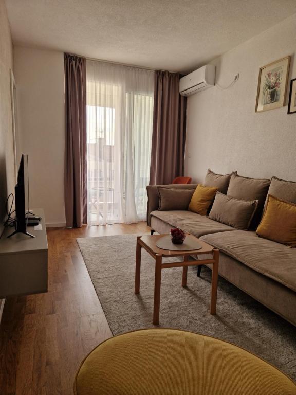 Una sala de estar con un sofá y una mesa de café. en Rosemary, en Podgorica
