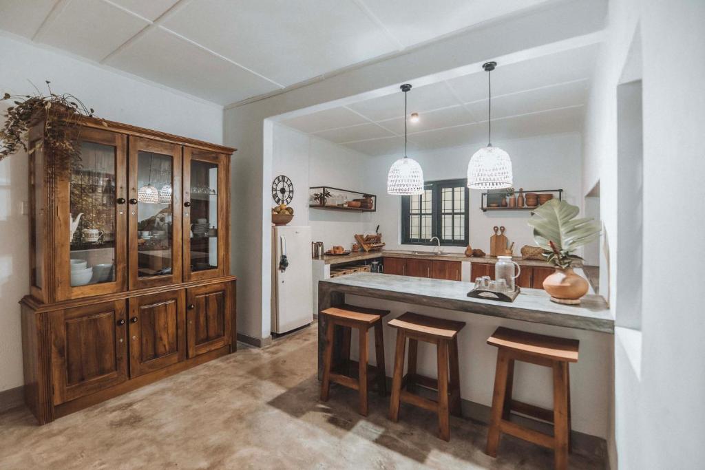 a kitchen with a large island with stools in it at Manril Landhouse Sri Lanka in Banduragoda