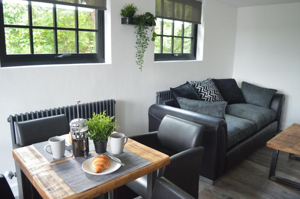 a living room with a table and a couch at Booking Urban at Halstead in Halstead