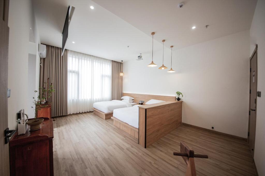 Postel nebo postele na pokoji v ubytování Meizhou Island Lijia Xiaoyuan B&B