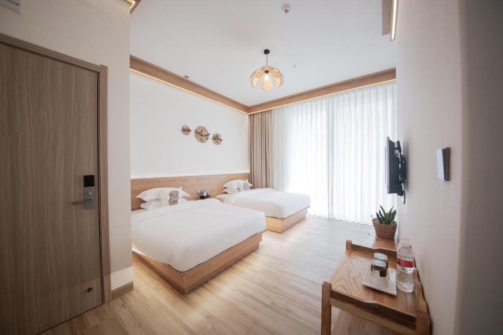 Postel nebo postele na pokoji v ubytování Meizhou Island Lijia Xiaoyuan B&B