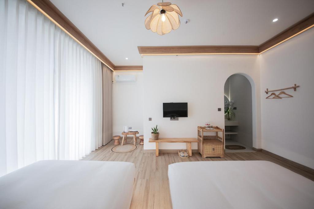 Postel nebo postele na pokoji v ubytování Meizhou Island Lijia Xiaoyuan B&B