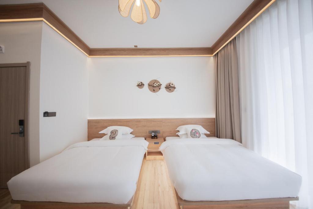 Postel nebo postele na pokoji v ubytování Meizhou Island Lijia Xiaoyuan B&B