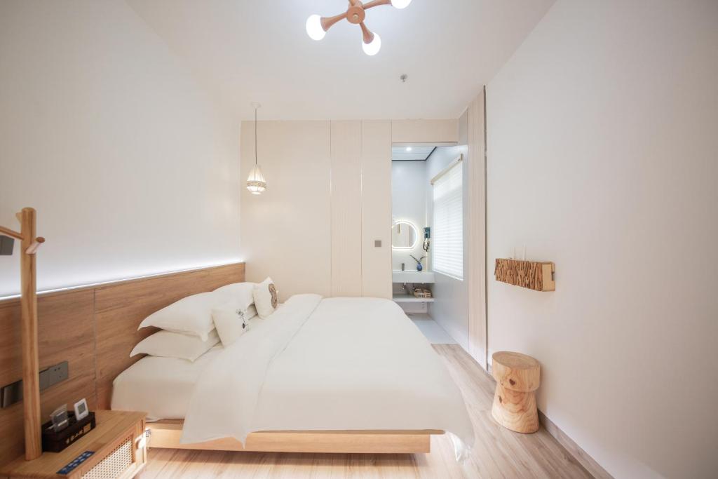 Postel nebo postele na pokoji v ubytování Meizhou Island Lijia Xiaoyuan B&B