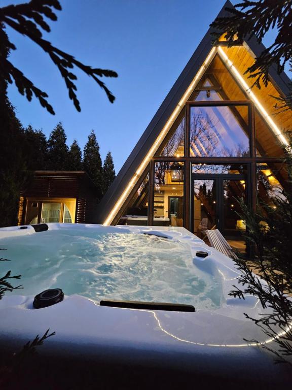a jacuzzi tub in front of a house at Navas River House in Poljane