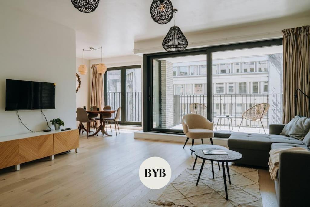 a living room with a couch and a tv at 2 bedroom apartment and private parking in Liège center in Liège