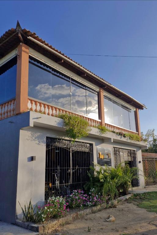 Una casa con una puerta y flores delante de ella. en Casa de Temporada Sitio Tope, en Aratuba