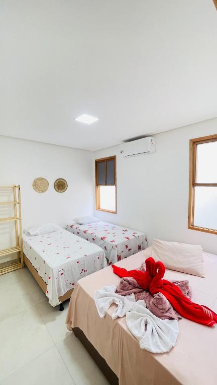Postel nebo postele na pokoji v ubytování Tô em Casa