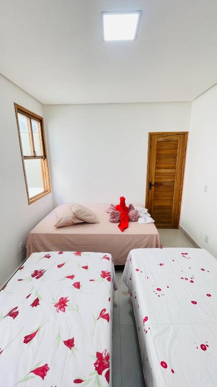 Postel nebo postele na pokoji v ubytování Tô em Casa