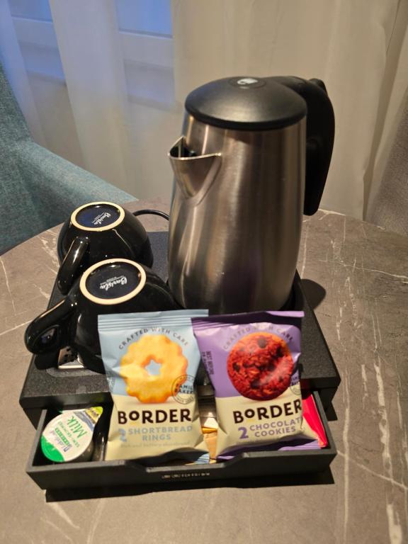 a table with a pot of coffee and some food at Maldron Hotel Brighton City Centre in Brighton & Hove