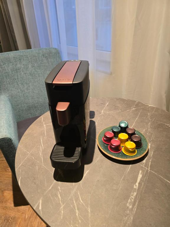 a coffee maker on a table next to a plate at Maldron Hotel Brighton City Centre in Brighton & Hove