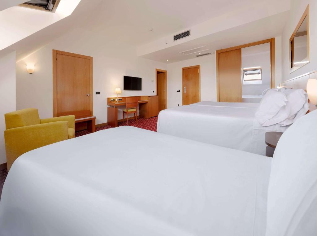 Postel nebo postele na pokoji v ubytování Hotel Zentral León