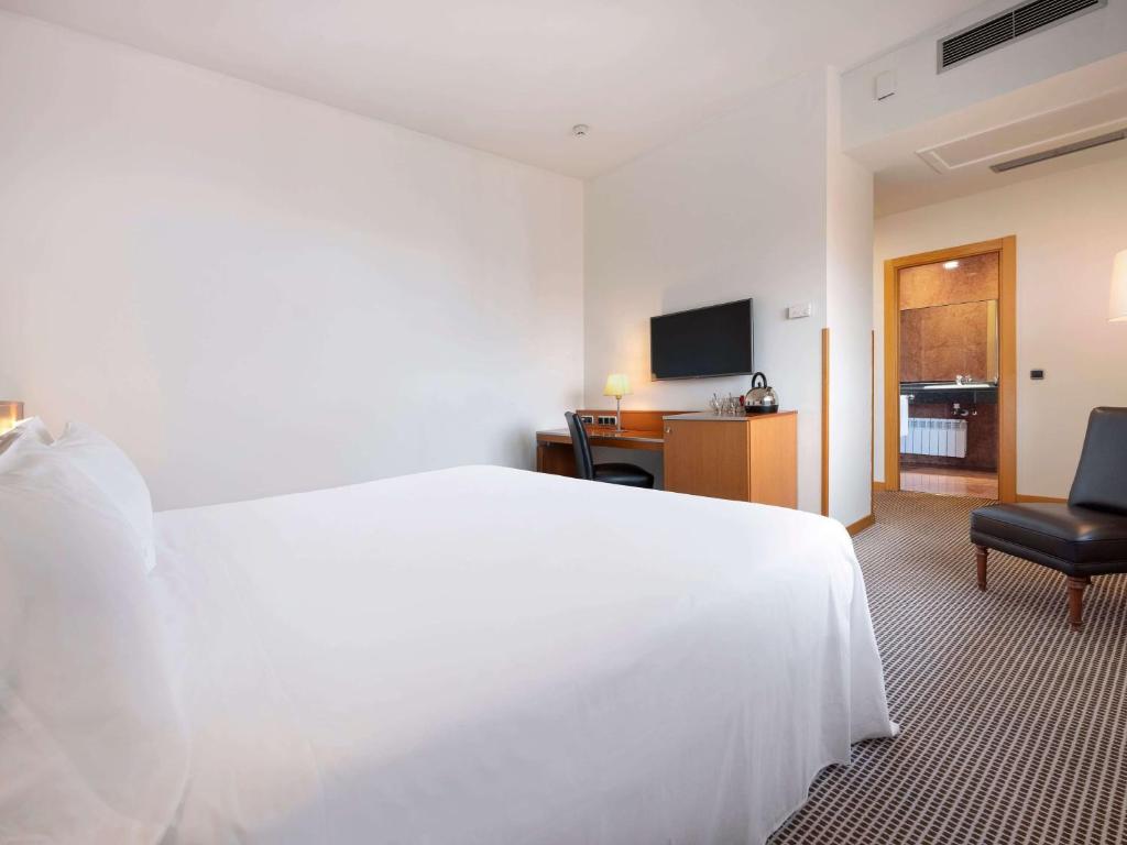 Postel nebo postele na pokoji v ubytování Hotel Zentral León