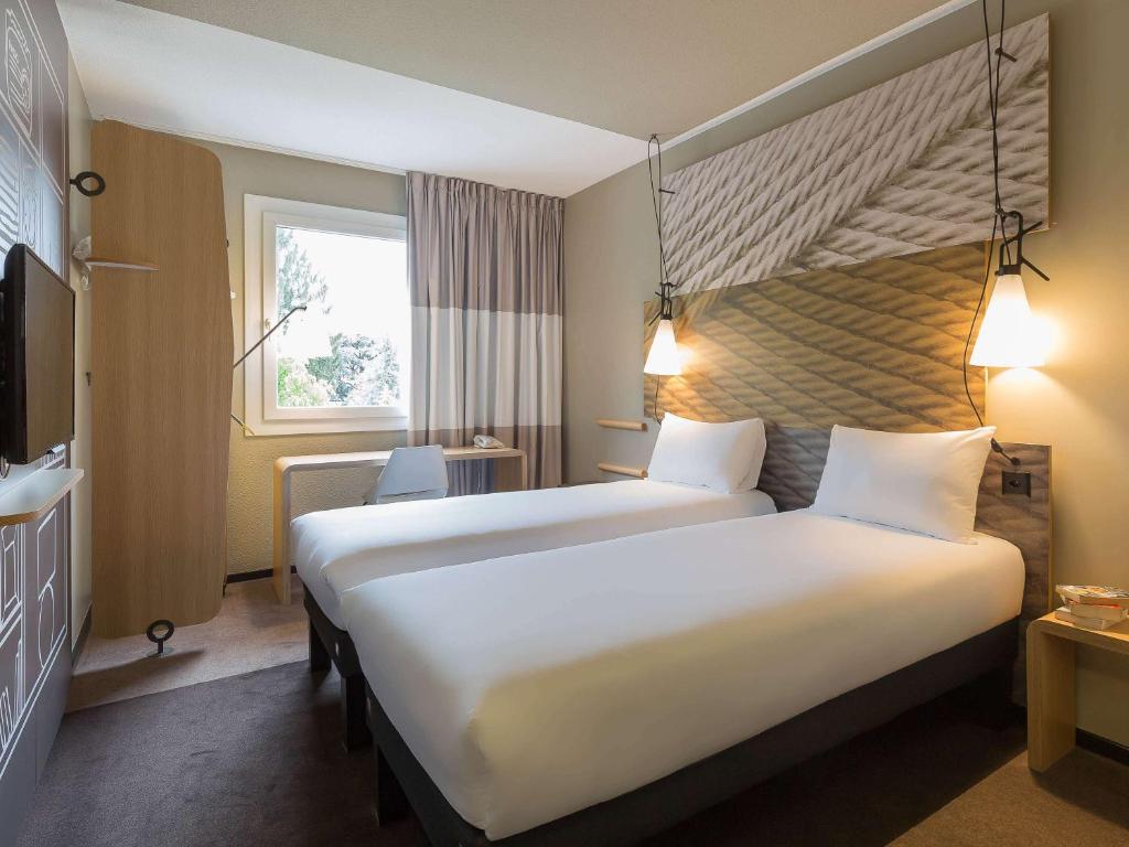 Postel nebo postele na pokoji v ubytování ibis Genève Aéroport