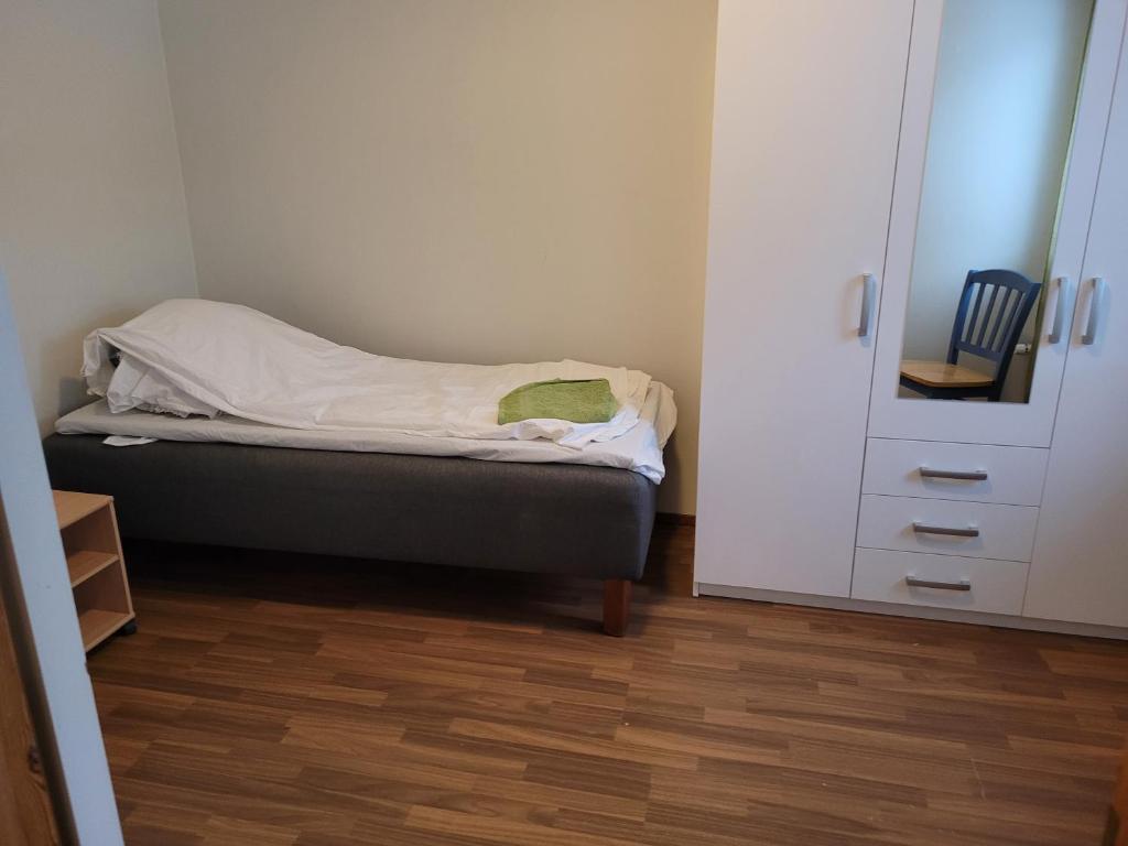a small bedroom with a bed and a closet at Harjukatu in Äänekoski
