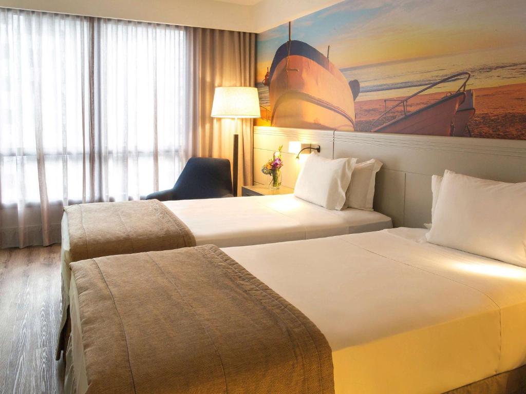 Postel nebo postele na pokoji v ubytování Novotel Florianopolis