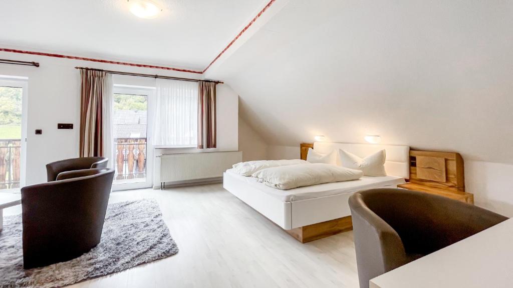 a bedroom with a white bed and two chairs at Smart Resorts B&B1 BB1 135 in Winterberg